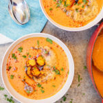 Two bowls of lentil pumpkin soup seen from above