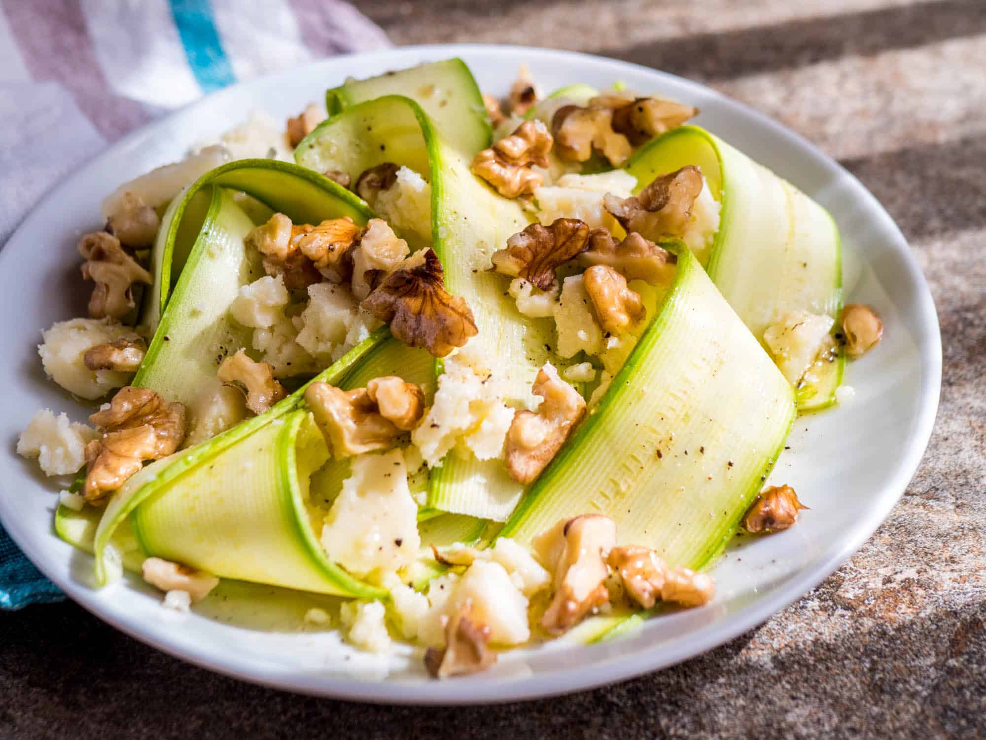 Raw zucchini salad with walnuts and mature cheese - recipe / A kitchen in Istanbul