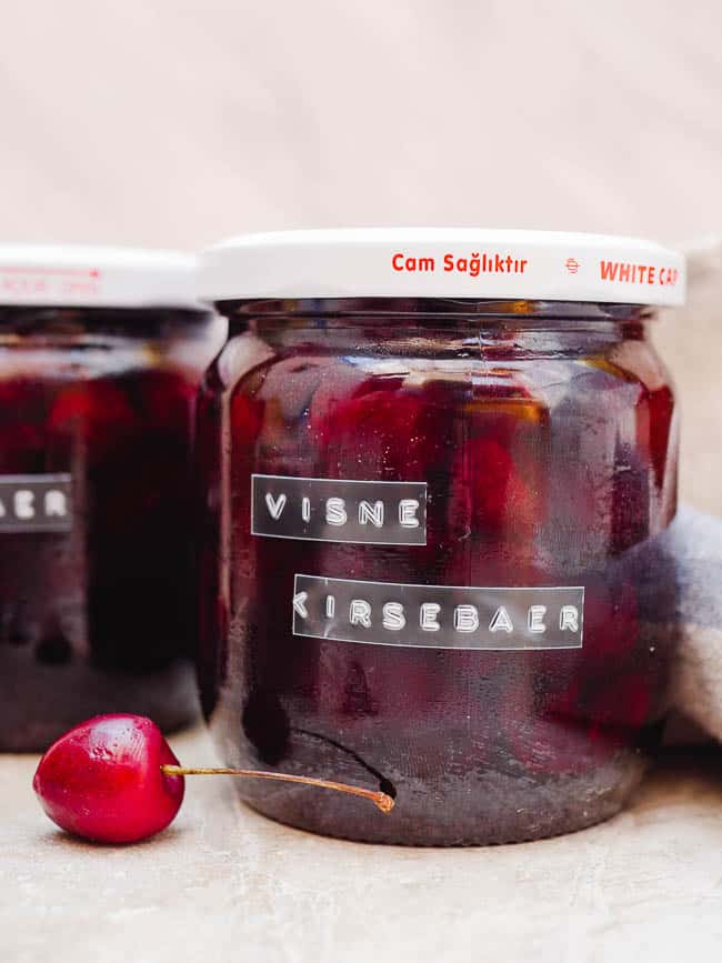 Turkish cherry jam in labelled jars, seen from the side