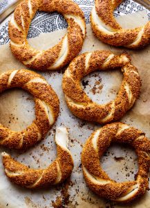 Simit side by side on baking parchment