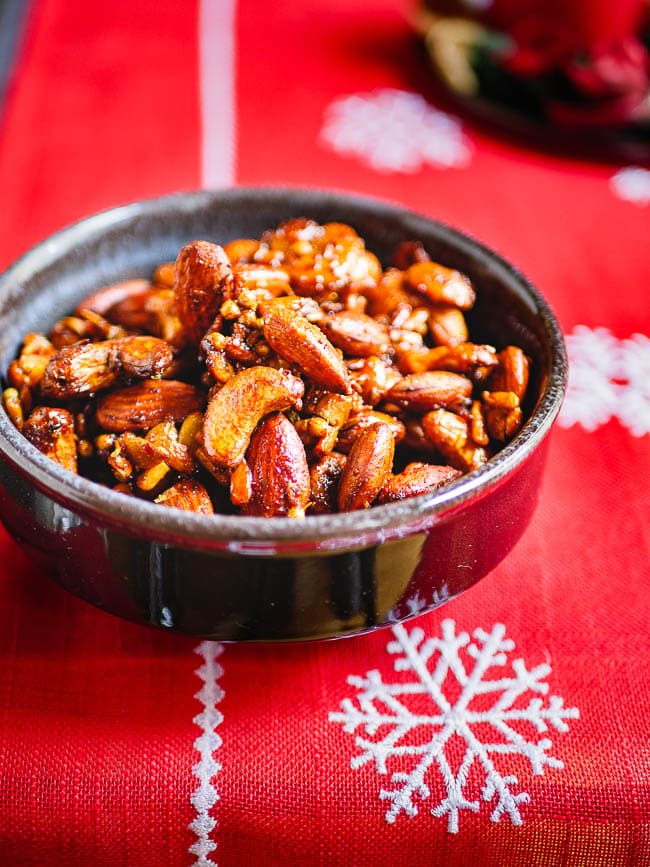 Middle Eastern spiced nuts in a bowl on red Christmas runner, seen from eye level