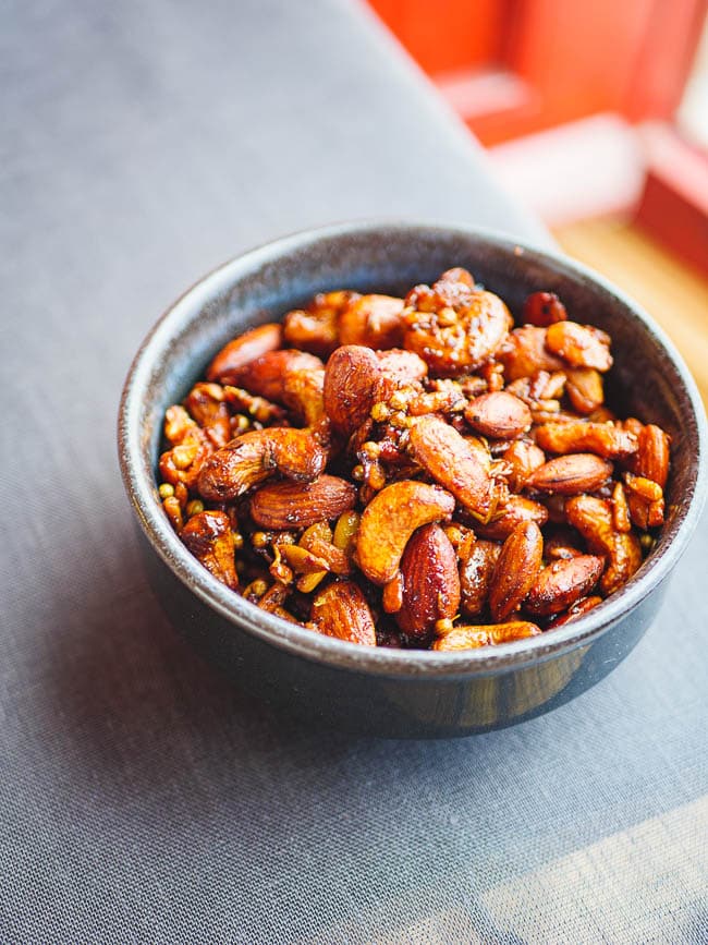 Middle Eastern spiced nuts in a bowl at corner of table, seen from eye level