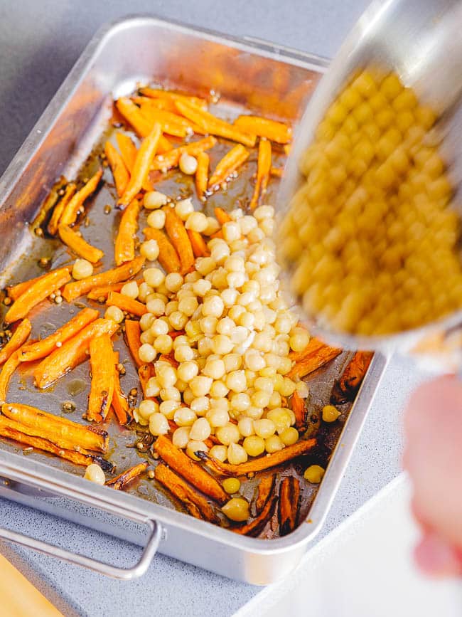 Cooked chickpeas added to roasted carrots