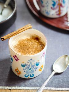 Salep in colourful cup with sprinkling of cinnamon seen from eye-level