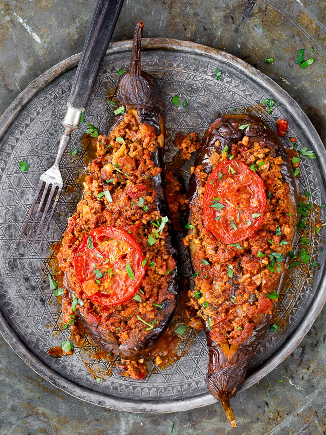 Two Turkish stuffed aubergine on old metal tray, seen from above