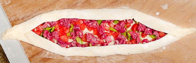 Turkish pide ready to go into oven, seen from above