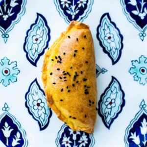 Pogaca with cheese on a patterned blue Turkish plate